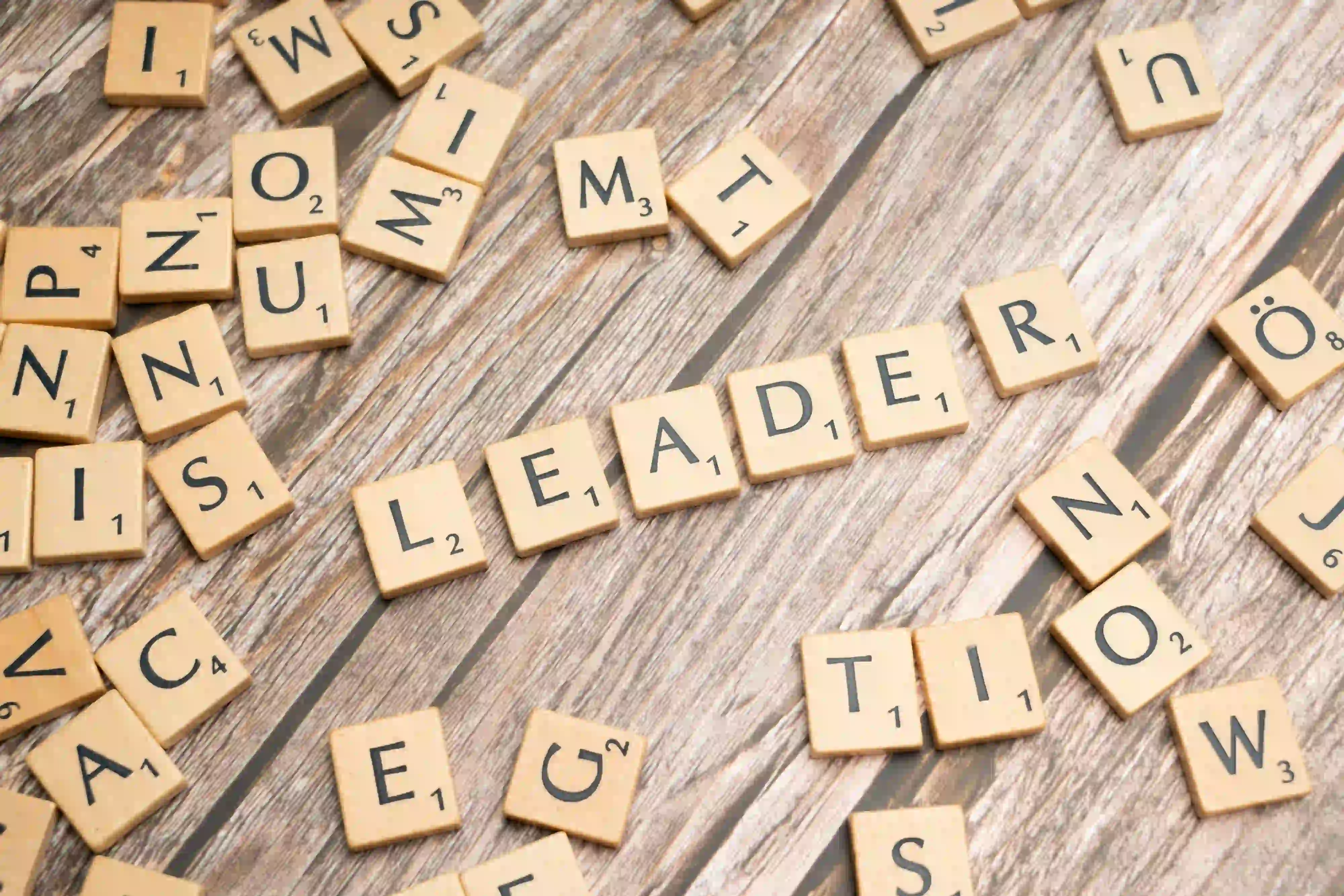 photo showing the scrabble pieces spelling “leader”